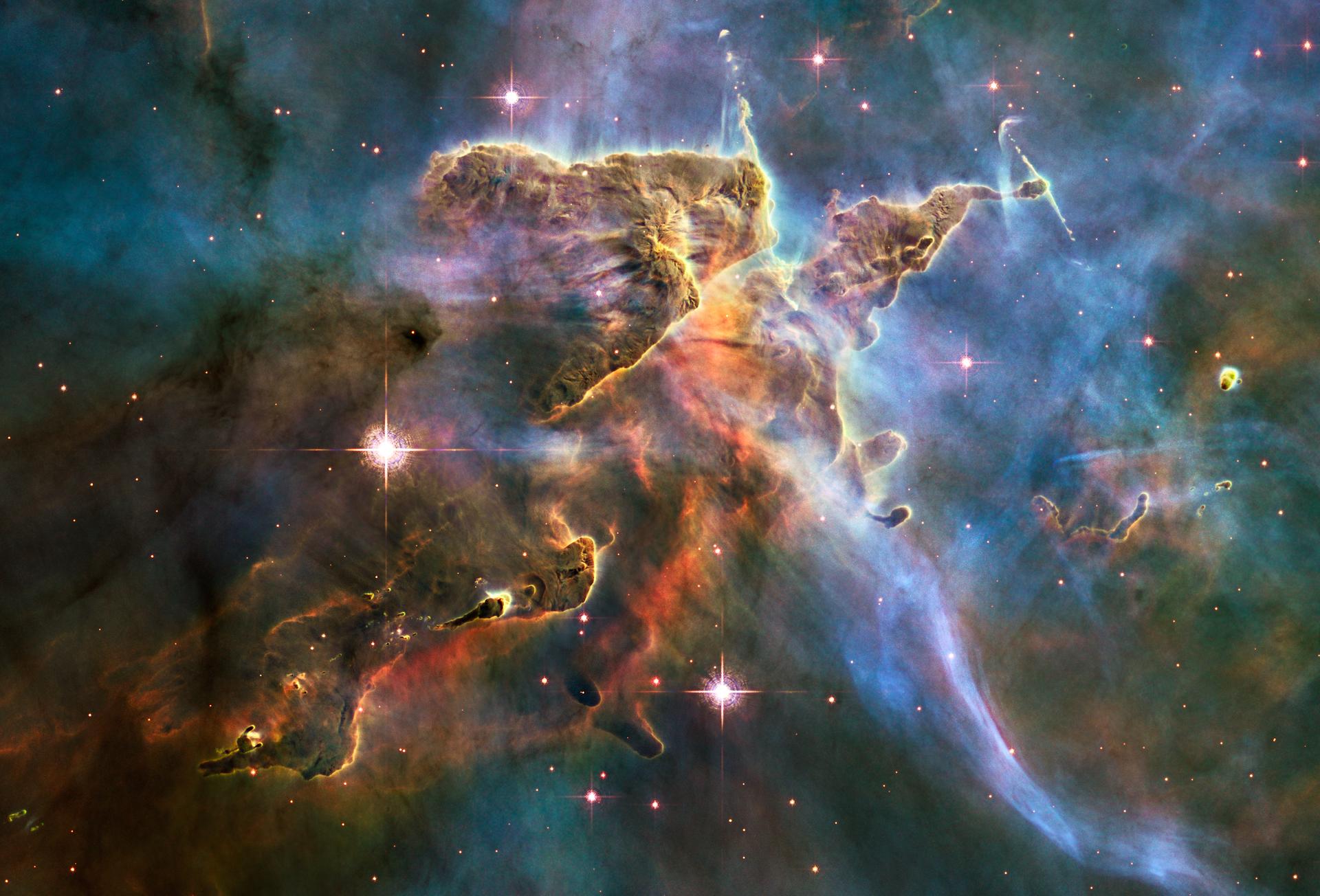 Carina Nebula star-forming region imaged by the Hubble Space Telescope, showing towering columns of gas and dust lit by nearby young stars.